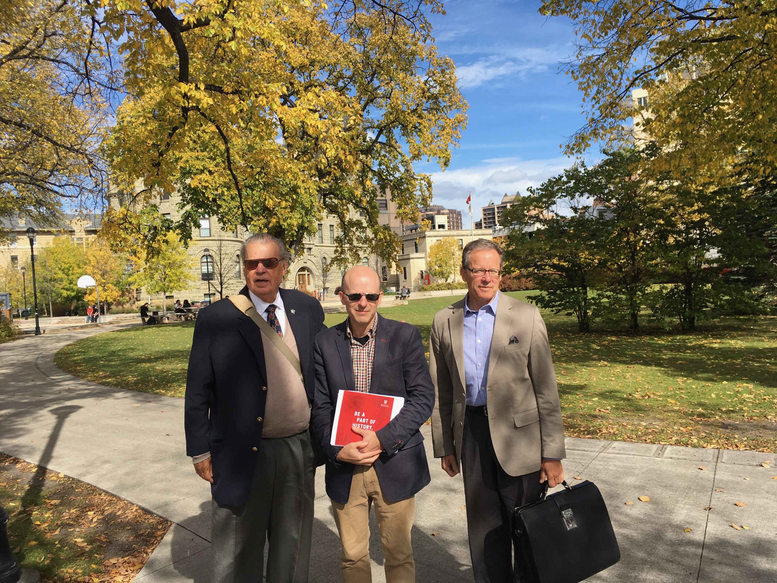 Joe Martin (L), Mark Bonham, and Dimitry Anastakis (R) of the CBHA pose for photo on the Winnipeg Lawn.