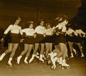 Black and white photo of group of women in rollerskating routine