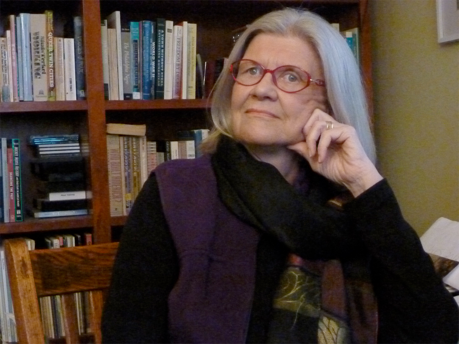 Photo of Linda Shopes in her office, background of bookcase.