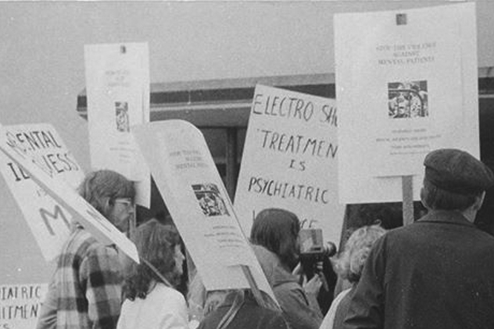 Black and white photograph of Vancouver’s Mental Patients Association picketing outside.